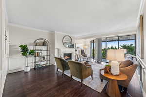 Living room featuring crown molding and hardwood / wood-style flooring