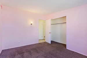 Unfurnished bedroom with a closet and carpet flooring