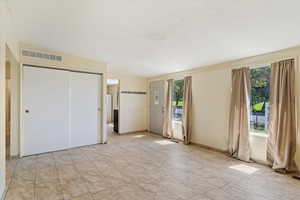 Unfurnished bedroom featuring light tile patterned floors and a closet