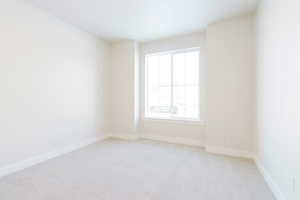 Spare room with light colored carpet