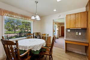 Dining area featuring an inviting chandelier and light hardwood / wood-style flooring