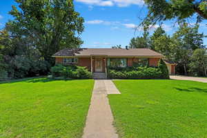 Ranch-style home with a front lawn