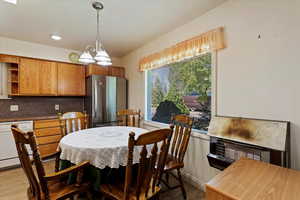 Dining space with light hardwood / wood-style flooring