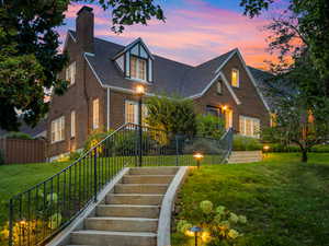 View of front of house featuring fully landscaped lawn