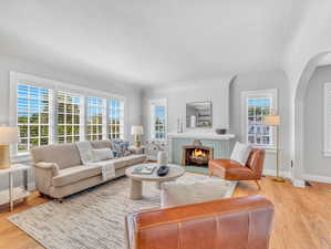 Living room featuring light hardwood / wood-style flooring and a tile fireplace