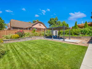 View of backyard with a pergola and a patio area