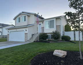 Tri-level home with a front yard and a garage