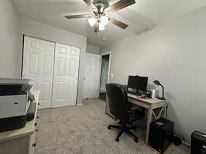 Office featuring ceiling fan and light carpet