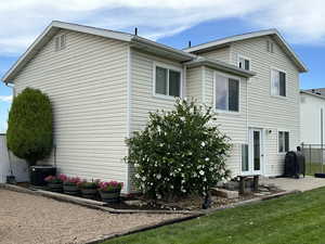 Rear view of property with a patio and cooling unit