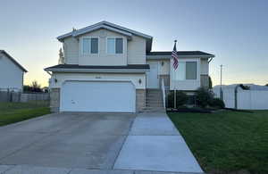 View of front of home with a lawn and a garage