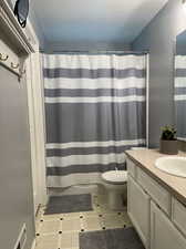 Bathroom with tile patterned floors, vanity, and toilet