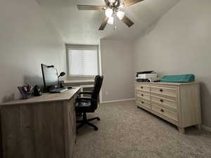 Carpeted office space featuring ceiling fan