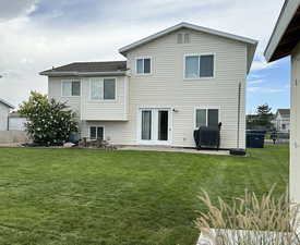 Back of house featuring a patio and a lawn