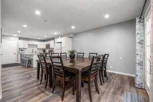 Dining space with hardwood / wood-style floors and sink