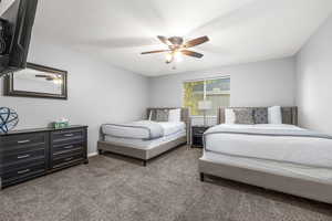 Bedroom featuring ceiling fan and carpet flooring