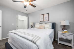 Bedroom with ceiling fan and dark carpet