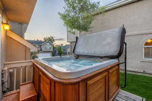 Pool at dusk featuring a hot tub