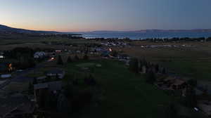 Aerial view at dusk featuring a water and mountain view