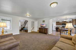 Living room featuring light carpet and a chandelier