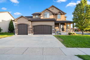 View of front of home featuring a front lawn and covered porch