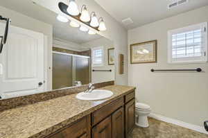 Bathroom with tile patterned floors, vanity, and toilet