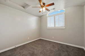 Carpeted spare room featuring ceiling fan and a textured ceiling