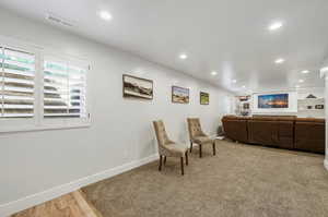 Living area featuring built in features and light wood-type flooring