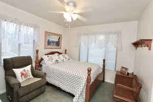 Main bedroom with large windows and closet space.