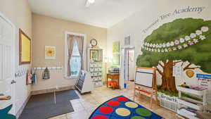 Game room with light tile patterned flooring