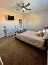 Carpeted bedroom with ceiling fan