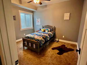 Bedroom featuring ceiling fan and carpet floors