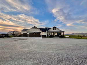 View of front of house featuring a carport and a garage