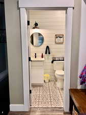 Bathroom featuring wood-type flooring, toilet, and vanity