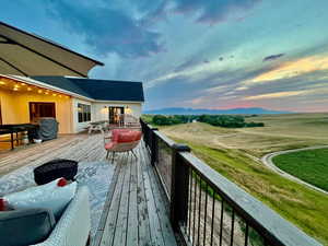 Deck at dusk featuring a mountain view and an outdoor hangout area