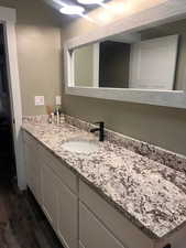 Bathroom featuring hardwood / wood-style flooring and vanity