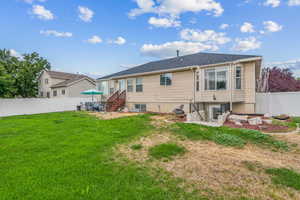 Rear view of house with a lawn