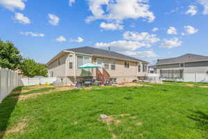 Back of property featuring a patio and a yard