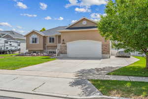 View of front of home with a front lawn and a garage