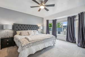 Carpeted bedroom with ceiling fan