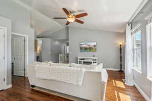 Living room featuring ceiling fan, vaulted ceiling, and hardwood / wood-style flooring