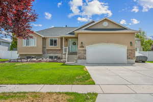 View of front of home featuring a front lawn and a garage