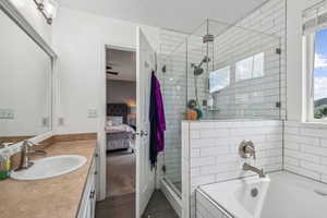 Bathroom with independent shower and bath, vanity, and tile patterned floors