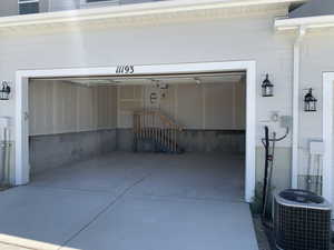 Garage featuring central AC unit (photos are not of actual home this is a previously built home)