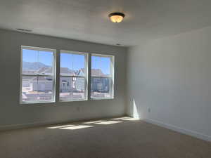 Unfurnished room featuring carpet and a textured ceiling (photos are not of actual home this is a previously built home)