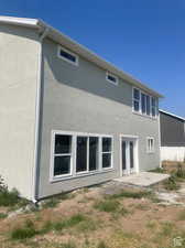 Rear view of house featuring a patio