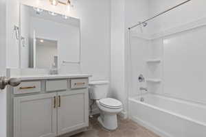 Full bathroom featuring tile patterned floors, vanity, toilet, and shower / tub combination