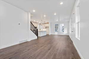 Unfurnished living room with dark hardwood / wood-style floors