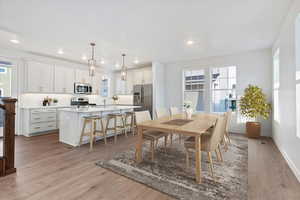 Dining room with light hardwood / wood-style floors and sink