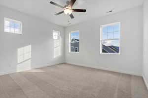 Unfurnished room with a healthy amount of sunlight and light colored carpet