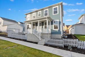 View of front of property with a porch and a garage